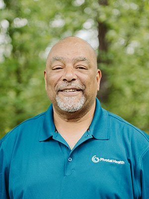 Pivotal Health team member in a blue polo smiling outdoors